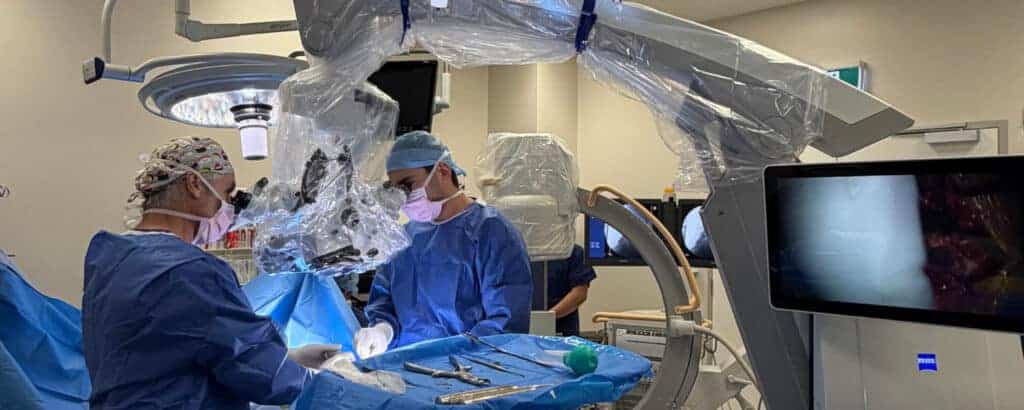 Dr David Edis and the surgical team performing spine surgery in theatre
