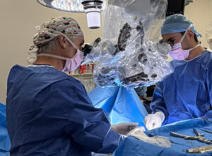 Dr David Edis and the surgical team performing spine surgery in theatre