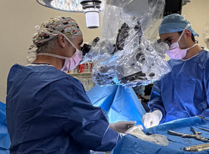 Dr David Edis and the surgical team performing spine surgery in theatre